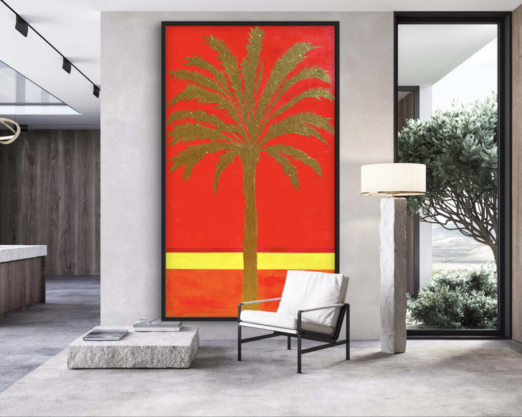 A modern living space featuring a large artwork of a palm tree set against a vibrant red background. The room includes a white armchair, a stone coffee table, and a lamp, along with large windows allowing natural light and a view of greenery outside. The decor combines minimalist and contemporary styles.