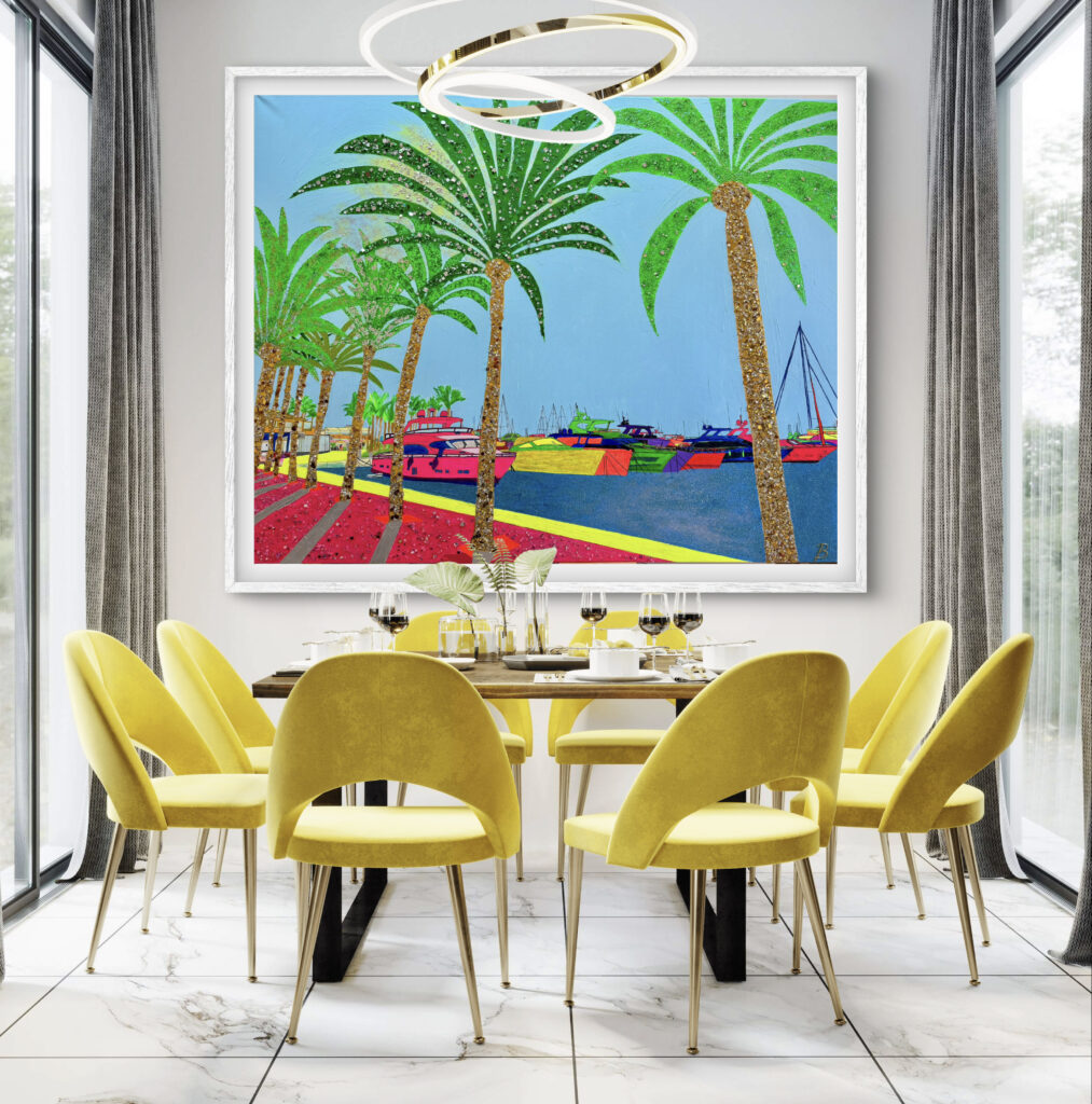 A modern dining room features a table surrounded by yellow chairs, with a large, colorful painting of palm trees and boats hanging on the wall. Natural light shines through large windows adorned with gray curtains.