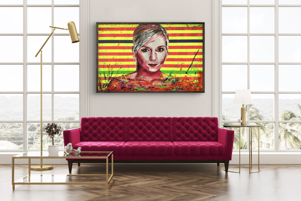 A vibrant interior scene featuring a bright pink tufted sofa in front of large windows. Above the sofa hangs a colorful painting of a face with bold, abstract stripes in the background. A modern floor lamp and a glass coffee table are also present in the room, alongside a small vase with flowers.